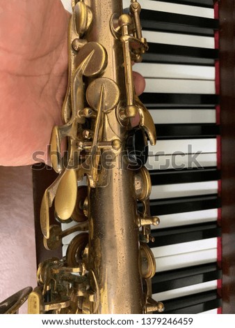 Musical instruments saxophone and piano keyboards