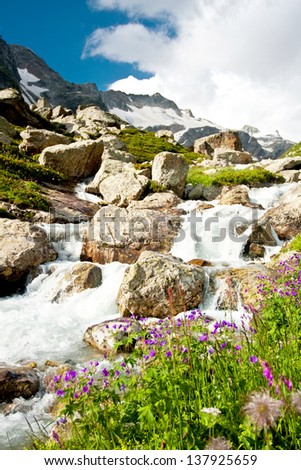 Mountain waterfall with clear blue water