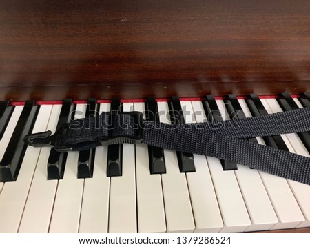 Neck strap saxophone on piano keyboards