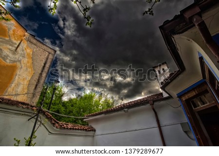 Extremely dramatic cloudy landscape with elements of the architecture of the Old Town in Plovdiv.