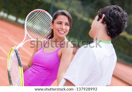 Couple of tennis players talking at the court