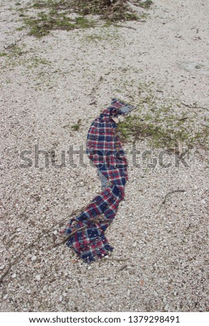 Forgotten woolen scarf on the ground due to hurry at old refugees camp