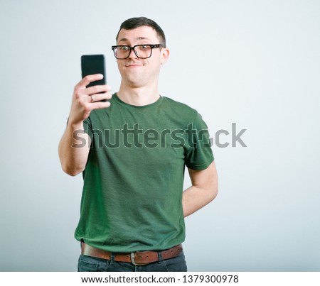 successful man making photo by phone, studio photo over background