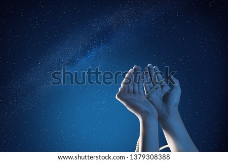 Muslim hands praying with prayer beads at outdoor with night scene background Royalty-Free Stock Photo #1379308388