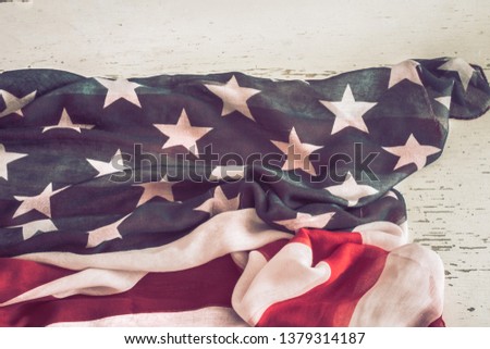 National Patriotic symbols. American flag on old white wooden background.The concept of patriotism and celebration