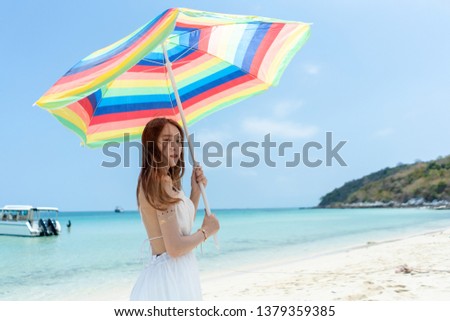 Asia beautiful traveler woman with umbrella on the beach concept tourism on summer holiday.