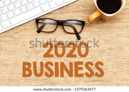 workplace : keyboard, eyeglasses and coffee cup on wood table, 2020 business concept