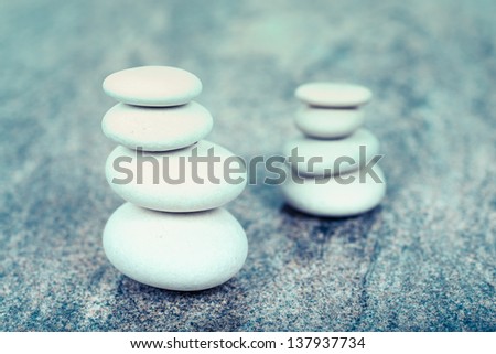 two stacks of white stones, only one in focus