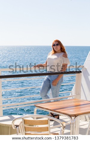 a beautiful girl is walking on the deck of the ship