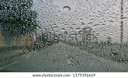 View through the wind shield of rainy day. Shallow depth of field composition. 