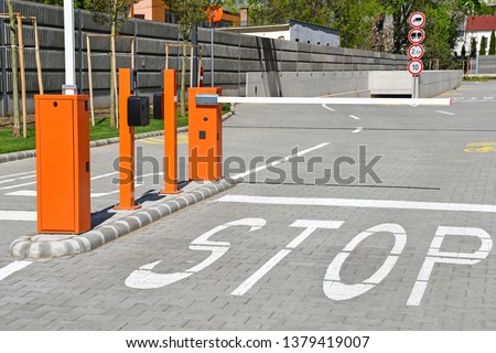 Parking lot gate and stop sign