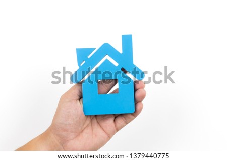 Hands protecting house,Man holding model house, close-up,house isolated on white background,property insurance and security.
