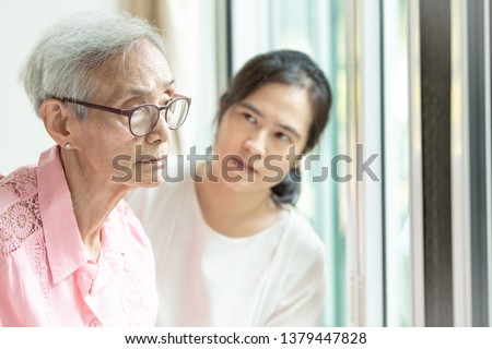 Elderly woman with depressive symptoms need close care,asian woman carer supporting,Alzheimer patient, 
depressed senior woman at home feeling sad,depression concept Royalty-Free Stock Photo #1379447828