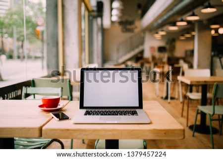 pretty girl sitting in hipster cafe, taking selfie, gdrinking coffee and using laptop