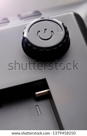 On off button with power adjustment function. Brilliant contacts of the connector for the battery in a plastic black case. Dark contrast view