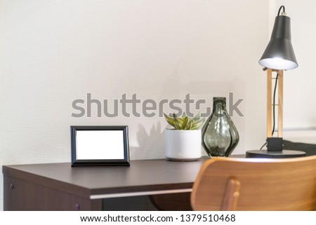 Empty picture frame placed on the desk in the bedroom
