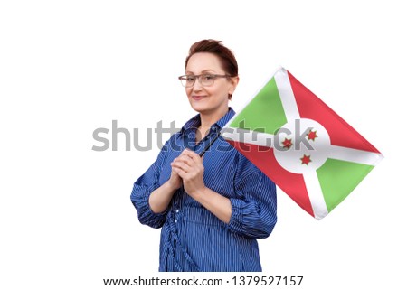 Burundi flag. Woman holding Burundi flag. Nice portrait of middle aged lady 40 50 years old holding a large flag isolated on white background.