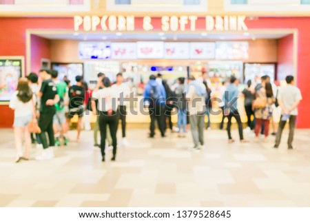 Blurred defocus of People buying popcorn, snack and soft drink in the new modern cinema food and soft drink counters. Blurred cinema lifestyle background.