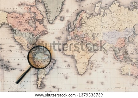 Top view of magnifying glass on world map 