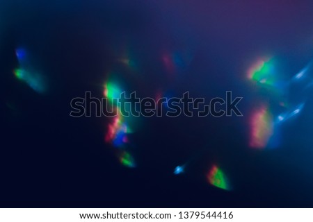 Blurred lens flare. Defocused colorful lights. Shiny glowing spots. Dark blue art abstract background. Royalty-Free Stock Photo #1379544416