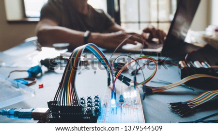 Modern technology. Student working at laboratory workstation. Microcontroller programming. Education and practical experience. Royalty-Free Stock Photo #1379544509