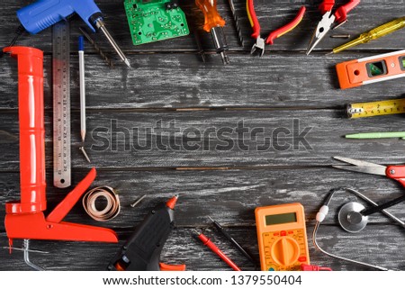 Top view of variety handy tools with different Jobs on black wooden background with copy space for your text for Worker's day, Labor's day, labour's day background.