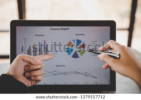 Business analysis concept. Businesswoman analyzing business documents, finacial report, working on laptop computer, mobile smart phone on office desk, close up. Royalty-Free Stock Photo #1379557712