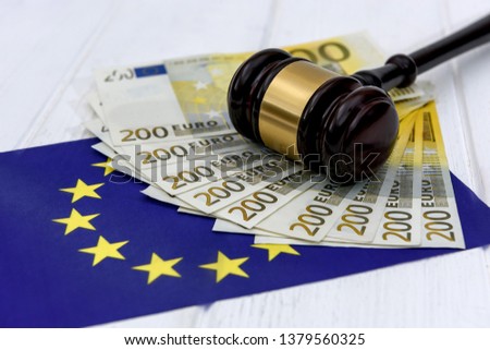 Euro banknotes with judge's gavel and european union flag