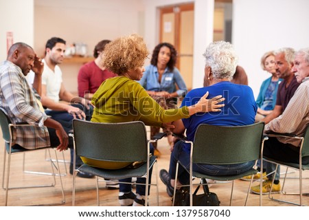 People Attending Self Help Therapy Group Meeting In Community Center Royalty-Free Stock Photo #1379587040