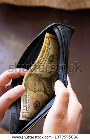 man hands with wallet and us dollar banknote. business makeing and saving money concept