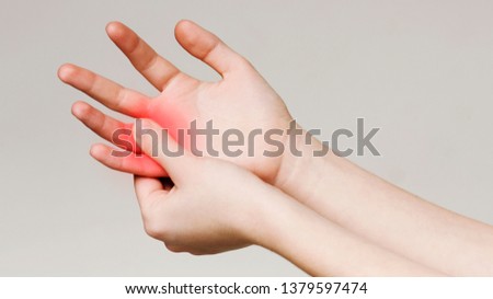 Pain and numbness in fingertips and palms. Woman massaging her sore hand, panorama