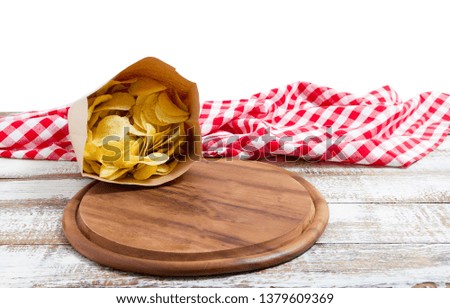 empty pizza board and tablecloth and potato chips pack on table isolated on white background copy space