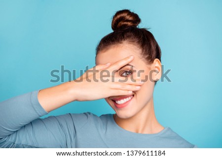 Close up photo beautiful she her lady arm hand fingers raised hide half face toothy beaming smile cute nice-looking friendly enjoy day off wear casual sweater pullover isolated blue bright background