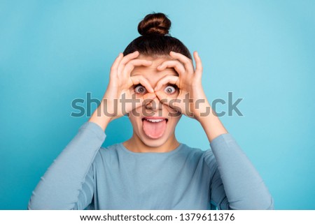 Close up photo of cute lovely teen teenager have free time vacation rest relax fooling make faces ridiculous foolish see watch wear fashionable pullover isolated on blue background