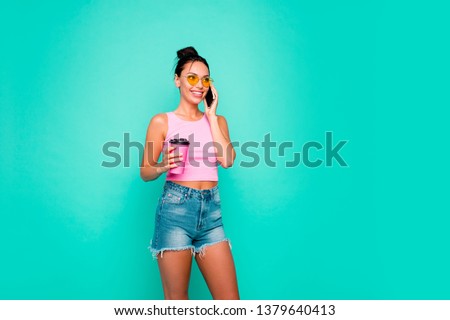 Close up photo beautiful she her lady funny hairdo hold hand arm takeaway beverage interested curious telephone speak tell wear casual tank-top jeans denim shorts isolated teal turquoise background