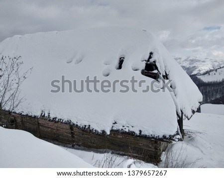 Nice winter landscape. Cabin in the Carpathian mountains covered with snow in Romania, Trasilvania, village of Parva.