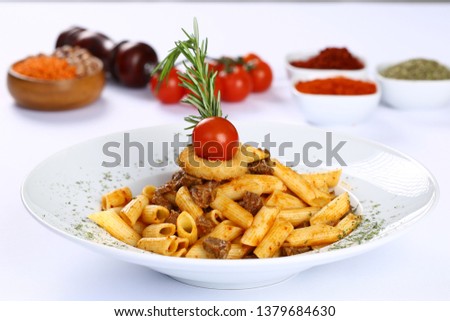 Italian Penne pasta in tomato sauce with beef meat