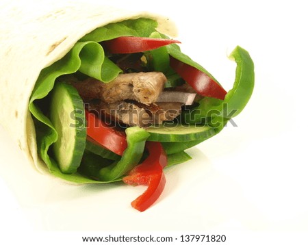 Close up of tortilla with meat and vegetables