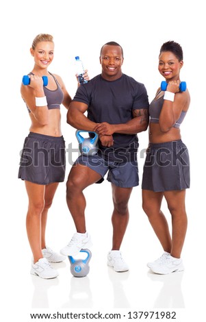 healthy group of young fit people with various gym equipment