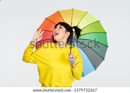    joyful woman holding a colorful umbrella                            