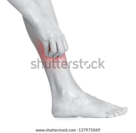 Women scratch itchy leg with hand. Healthcare And Medicine Concept photo with colour enhanced skin to emphasize problematic part.