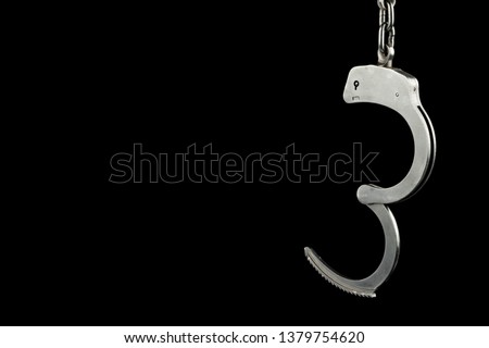 Handcuffs on a black background with copy space Royalty-Free Stock Photo #1379754620