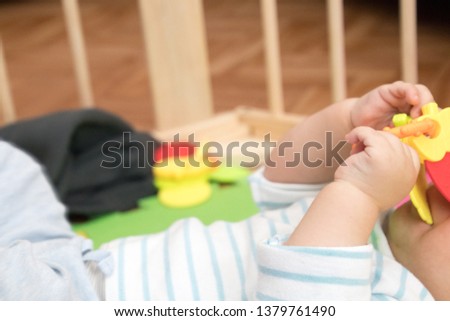 Close-up picture, A baby playing with his toys
