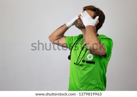 Photography of a veterinary doctor covering the eyes, facing forwards and looking at the horizon