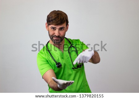 Photography of a veterinary doctor pointing at an object in the other hand, looking at the camera
