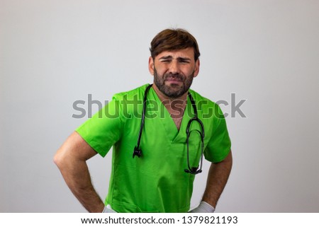 Photography of a veterinary doctor looking pain, their back facing the camera and looking at the camera