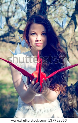 Girl with red origami crane