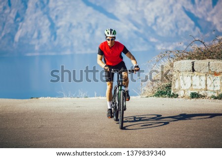 Man ride mountain bike on the road. Sport and active life concept.