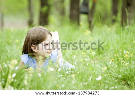 Girls lying on green grass outdoors in the park