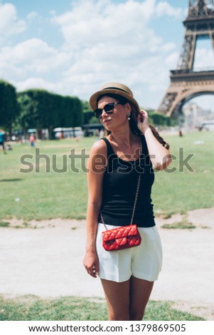 Paris woman happy and smiling, Fashion young blonde woman portrait in front of the Eiffel Tower in Paris, France.